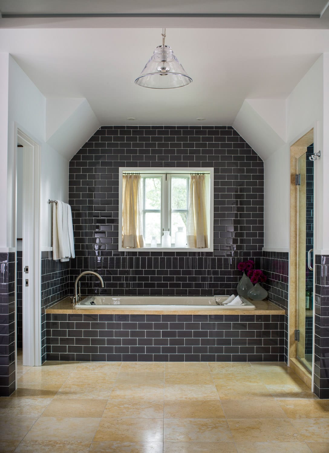 Modern bathroom with cobalt blue subway tiles and pendant light.