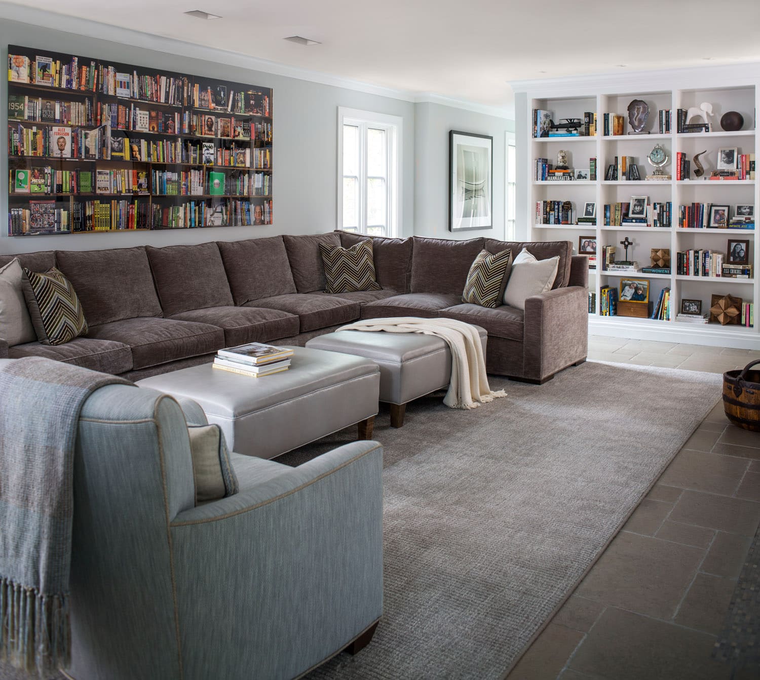 Cozy living room with sectional sofa and bookshelves.