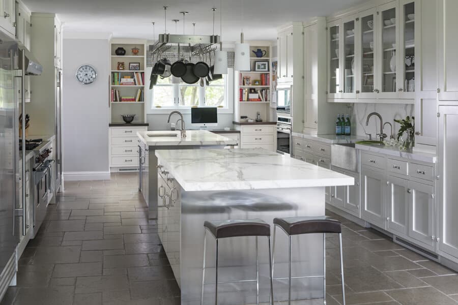 Modern kitchen interior with island and stainless appliances.