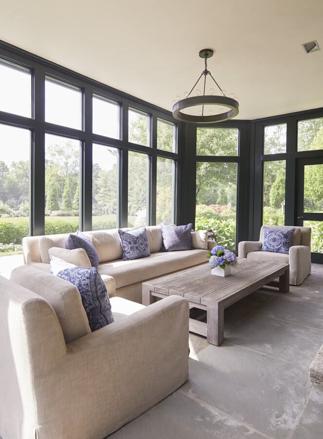 Elegant sunroom with beige sofas and large windows