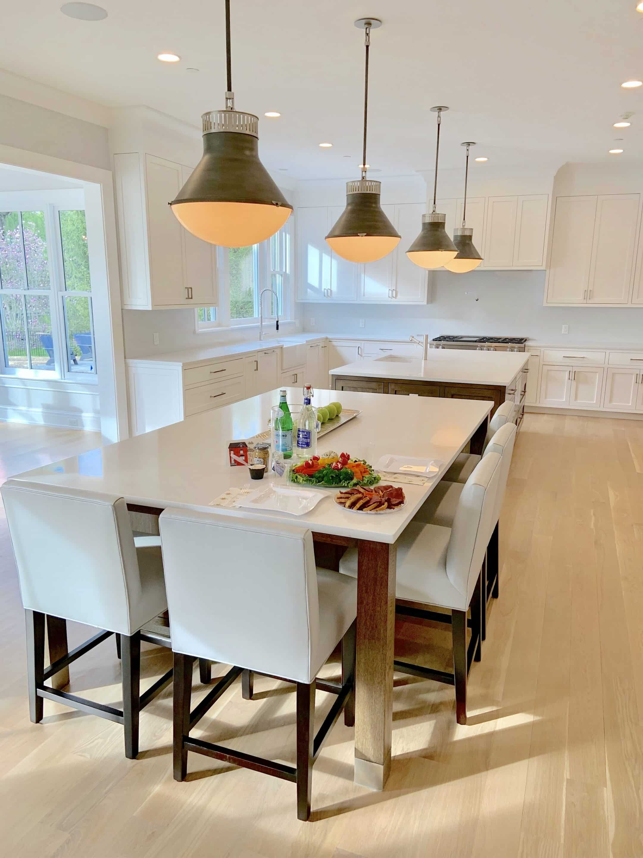 Modern kitchen interior with island and pendant lights.