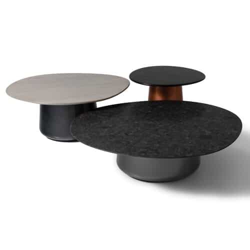 Modern round coffee tables on white background.