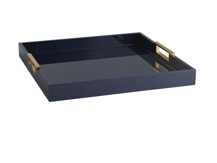Navy blue serving tray with gold handles.