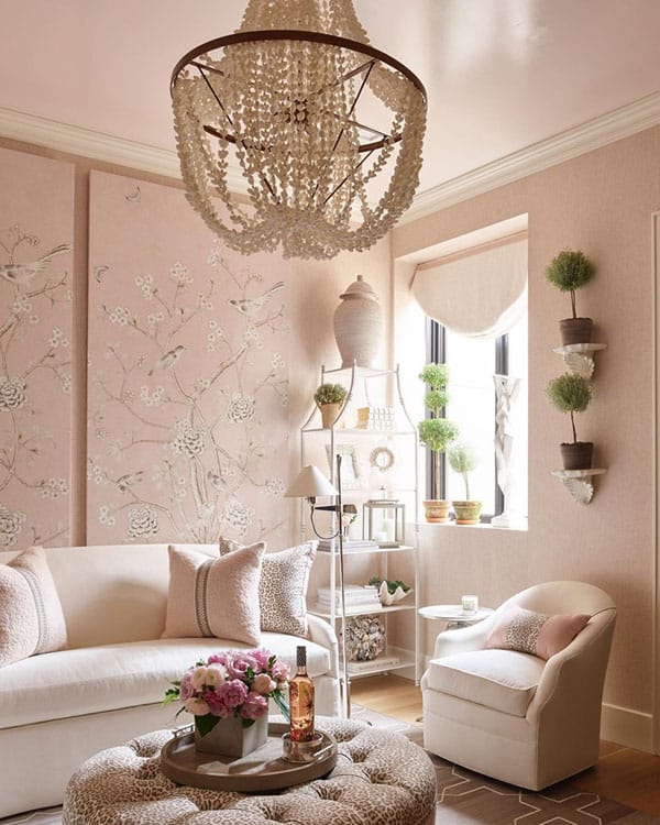 Elegant living room with chandelier and floral wallpaper design.