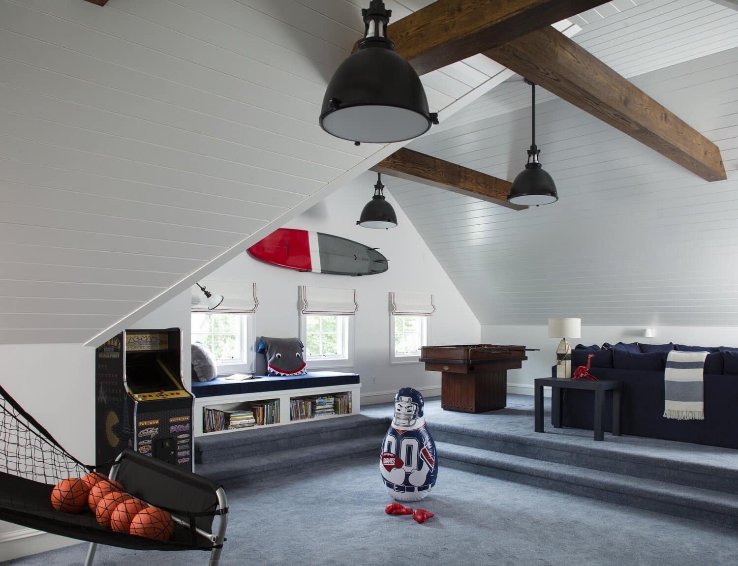 Spacious attic game room with modern decor.