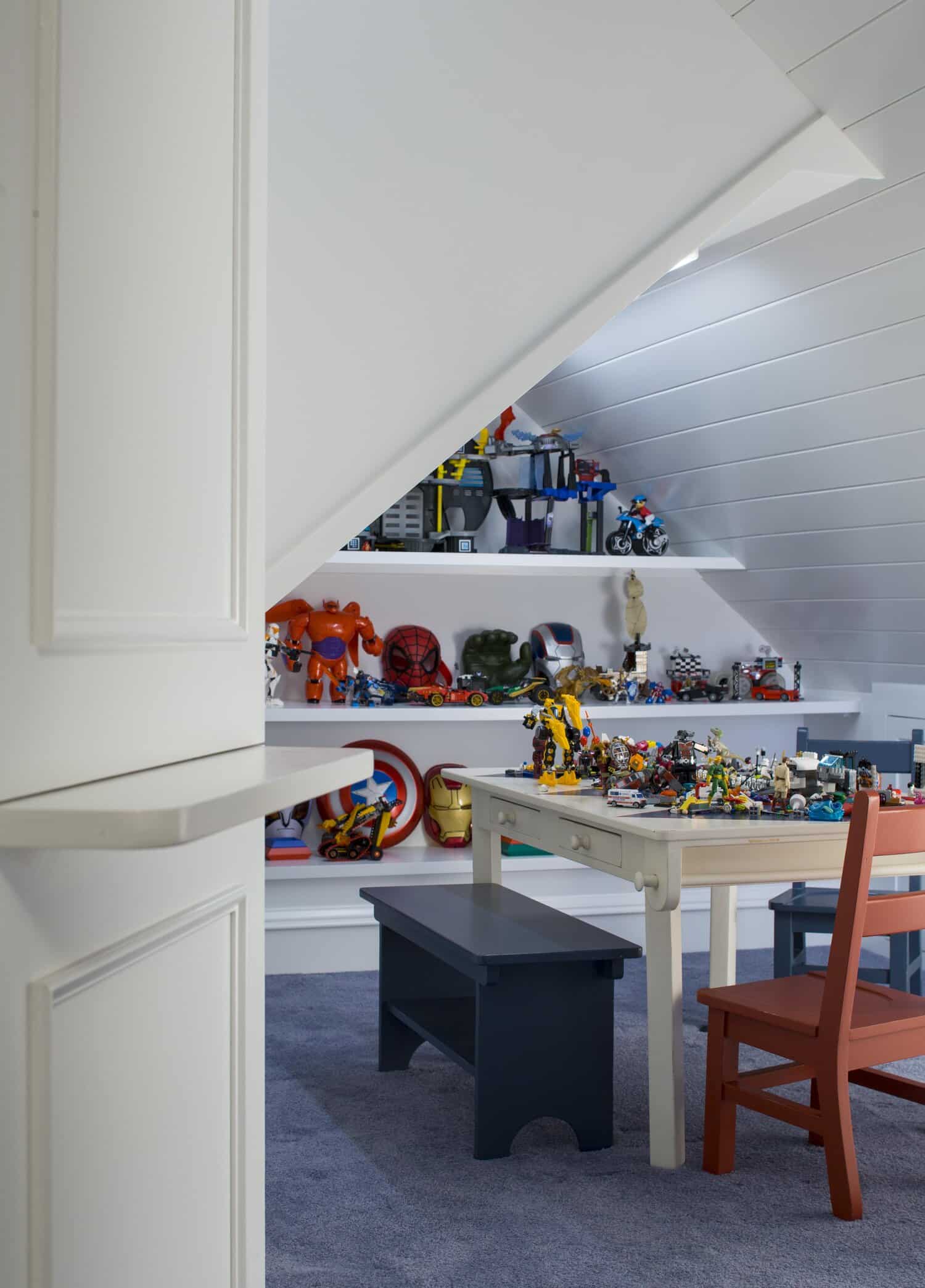 Attic playroom with toys and children's table.