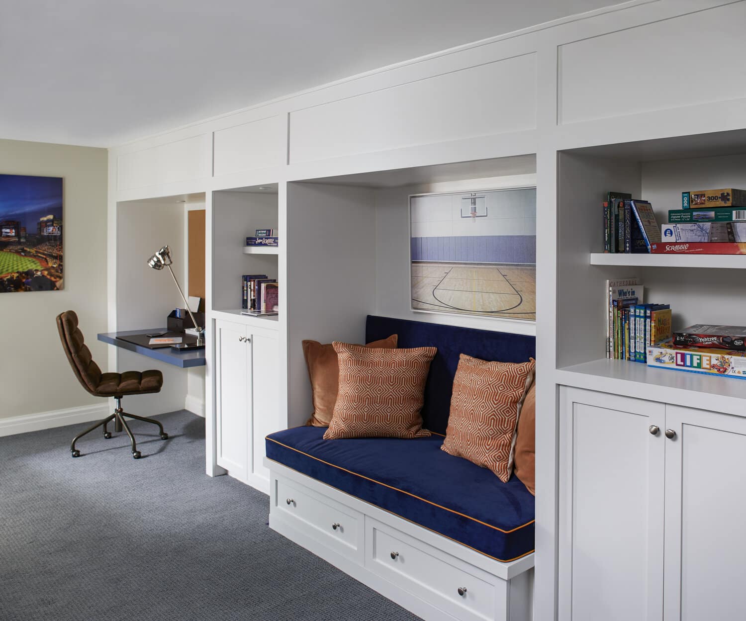 Modern home office with built-in desk and bookshelves.