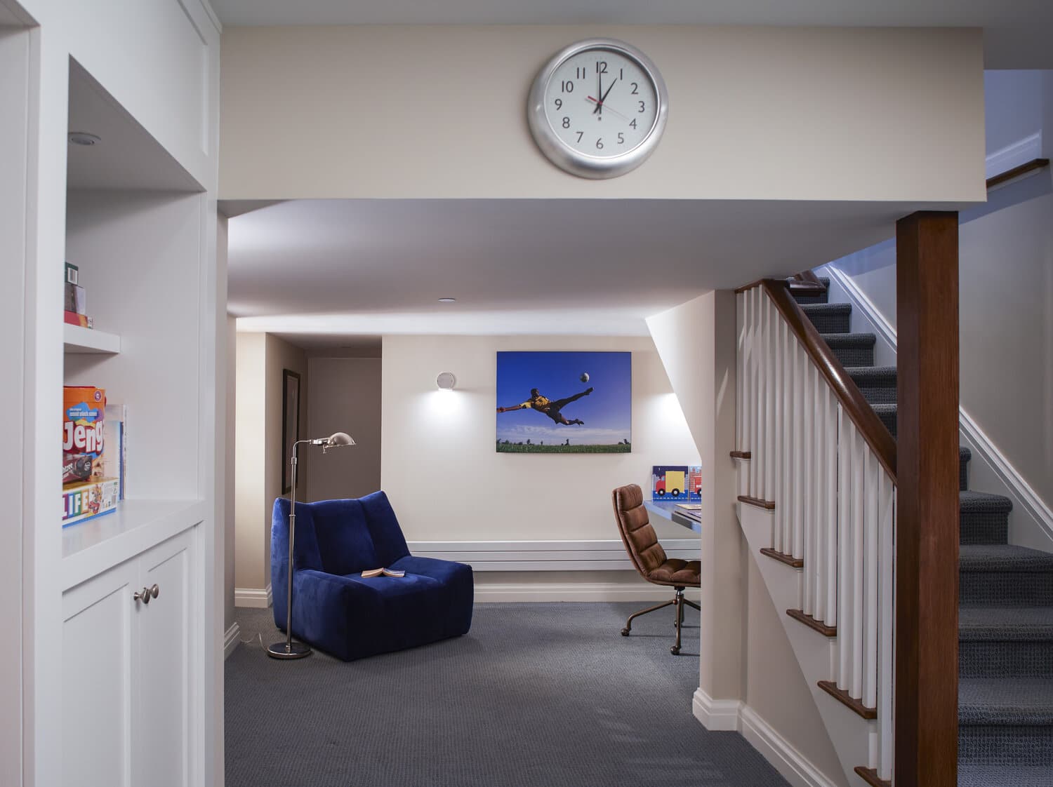 Modern basement interior with staircase and lounge area.