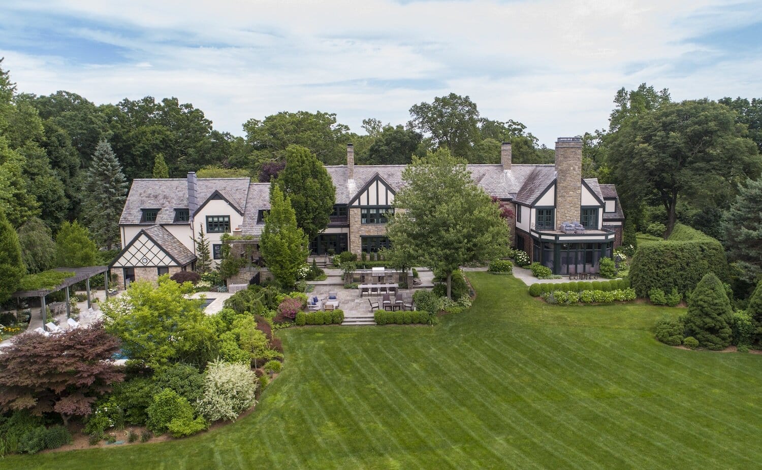 Luxurious estate aerial view with manicured gardens.