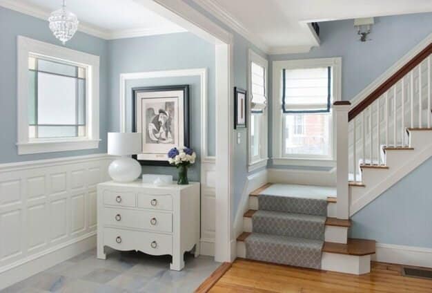 Bright entryway with staircase and hardwood floors.