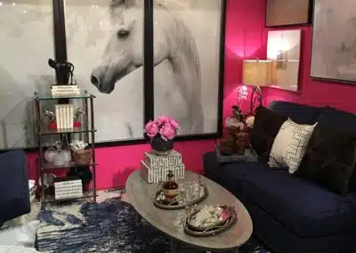 Elegant interior with horse art and vibrant red walls.