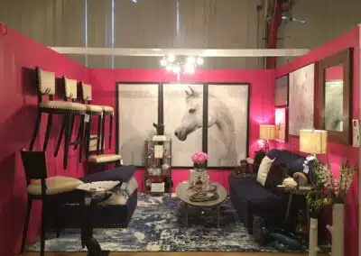Eclectic living room decor with pink walls and horse art.