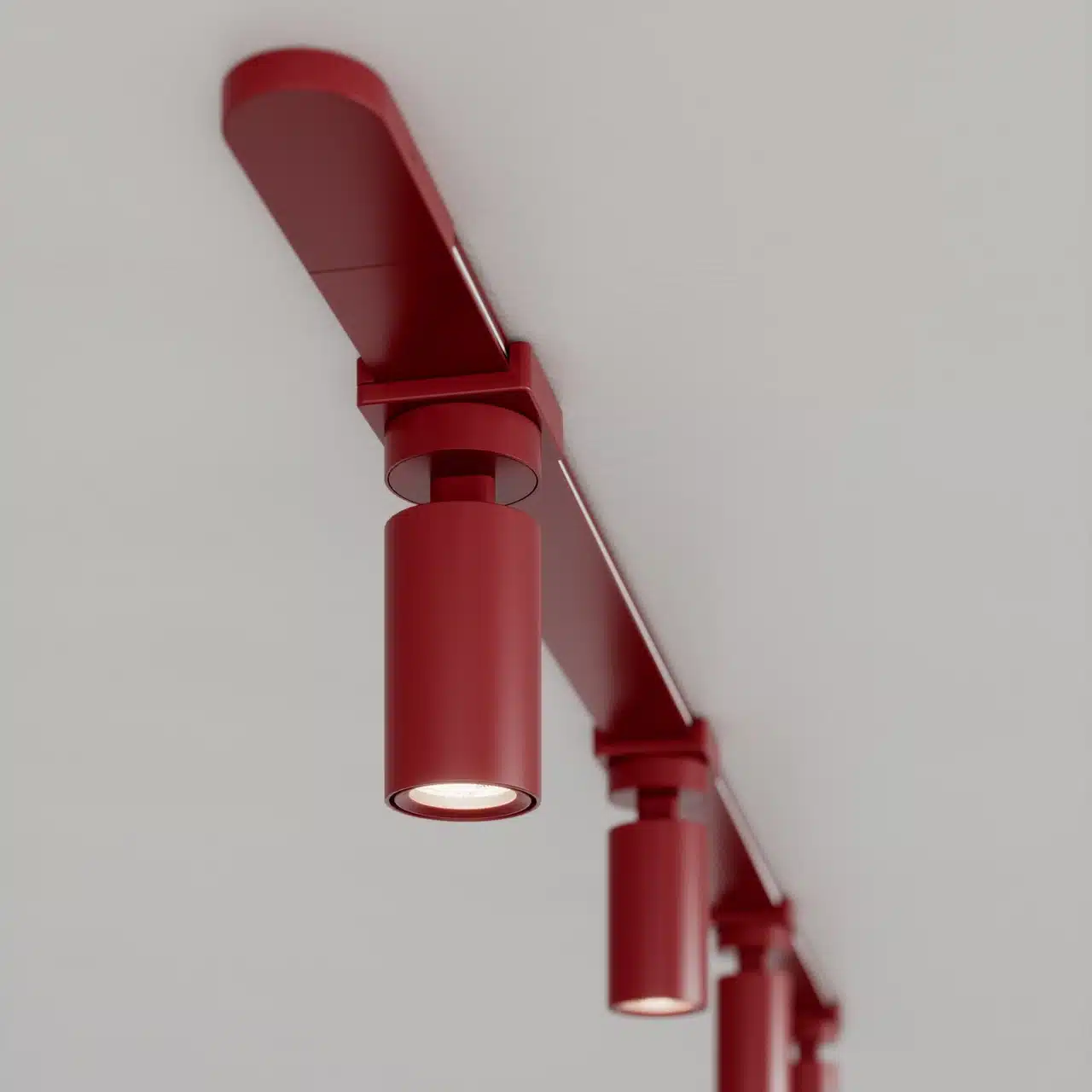Red track lighting fixtures on white ceiling