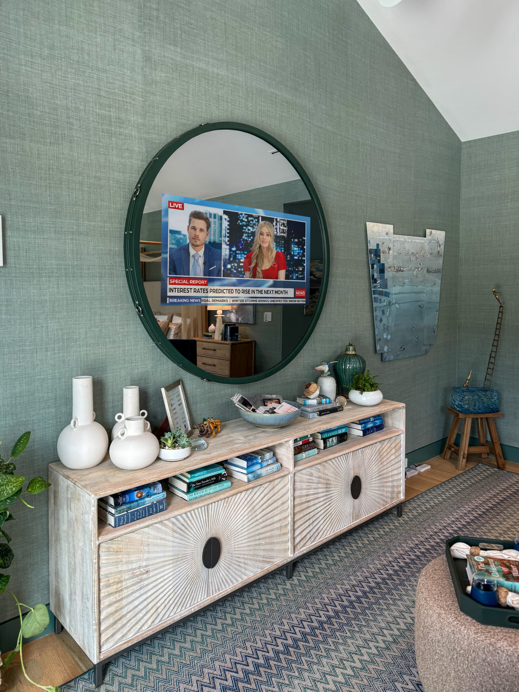 Living room with mirror reflecting television news broadcast.